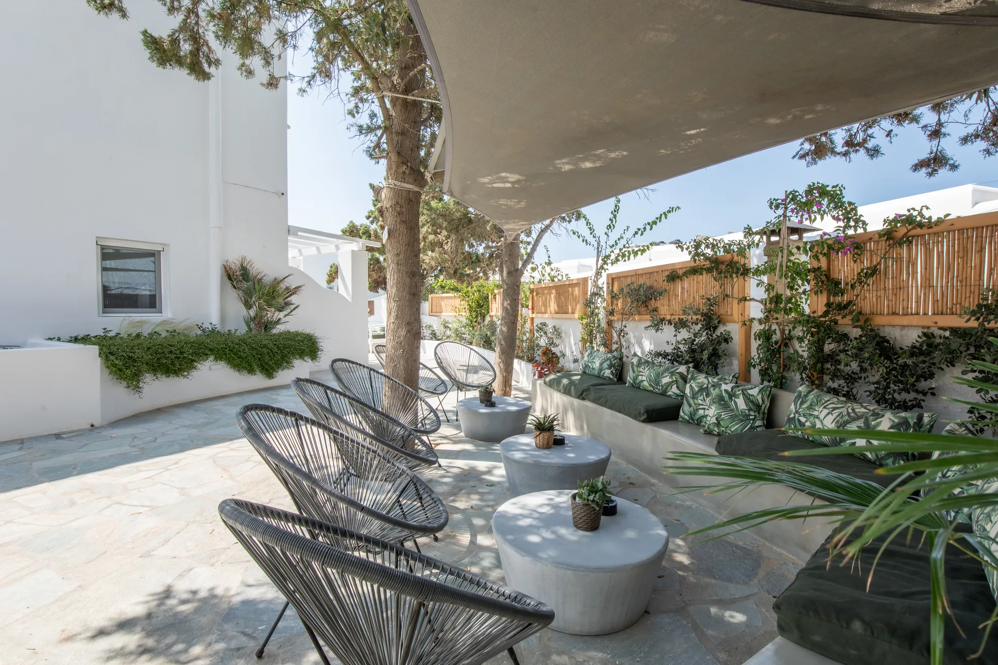 Shaded garden lounge with black rope chairs
